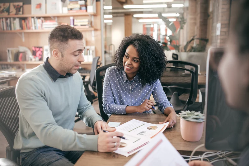 Two colleagues in a one-to-one coaching conversation